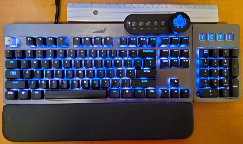 my Mountain Everest Max keyboard, in YETI lighting mode and with a ruler for scale.