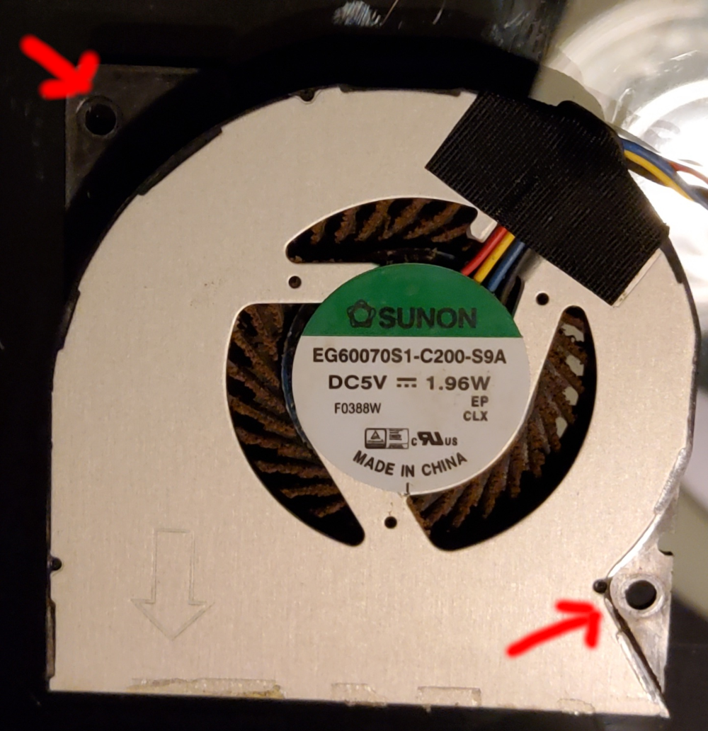 The factory PN5x fan with arrows pointing oput the location of the 2 screws securing it in place.
