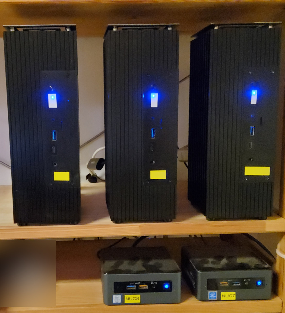 Our three PN5x in Turing A50 MKII cases. A NUC7 and a NUC8 are also shown, mainly for scale.